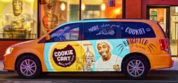 A delivery van features a a colorful, branded 3M graphic vehicle wrap.