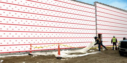 Person working on a building using 3M™ Vapor Permeable Air Barrier 3015VP

