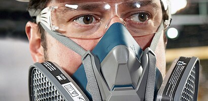 A person wearing a respirator and goggles
