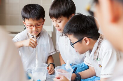 A group of boys in lab coats
