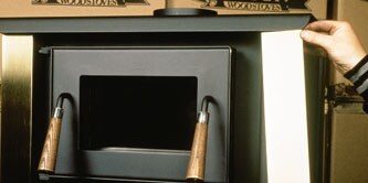 A person attaching decorative trim to an appliance

