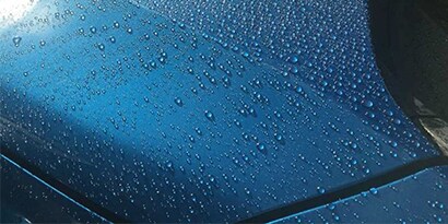 Water droplets on a blue surface
