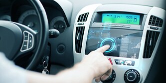 Image of man using car control panel.
