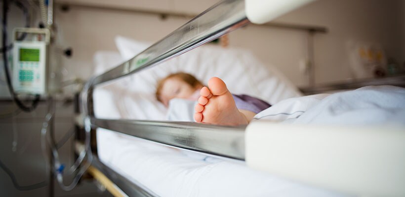 child in medical bed
