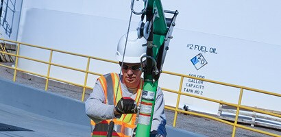 Workers operating winch on vertical retrieval davit
