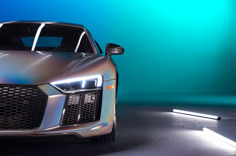 silver sports car with lights on
