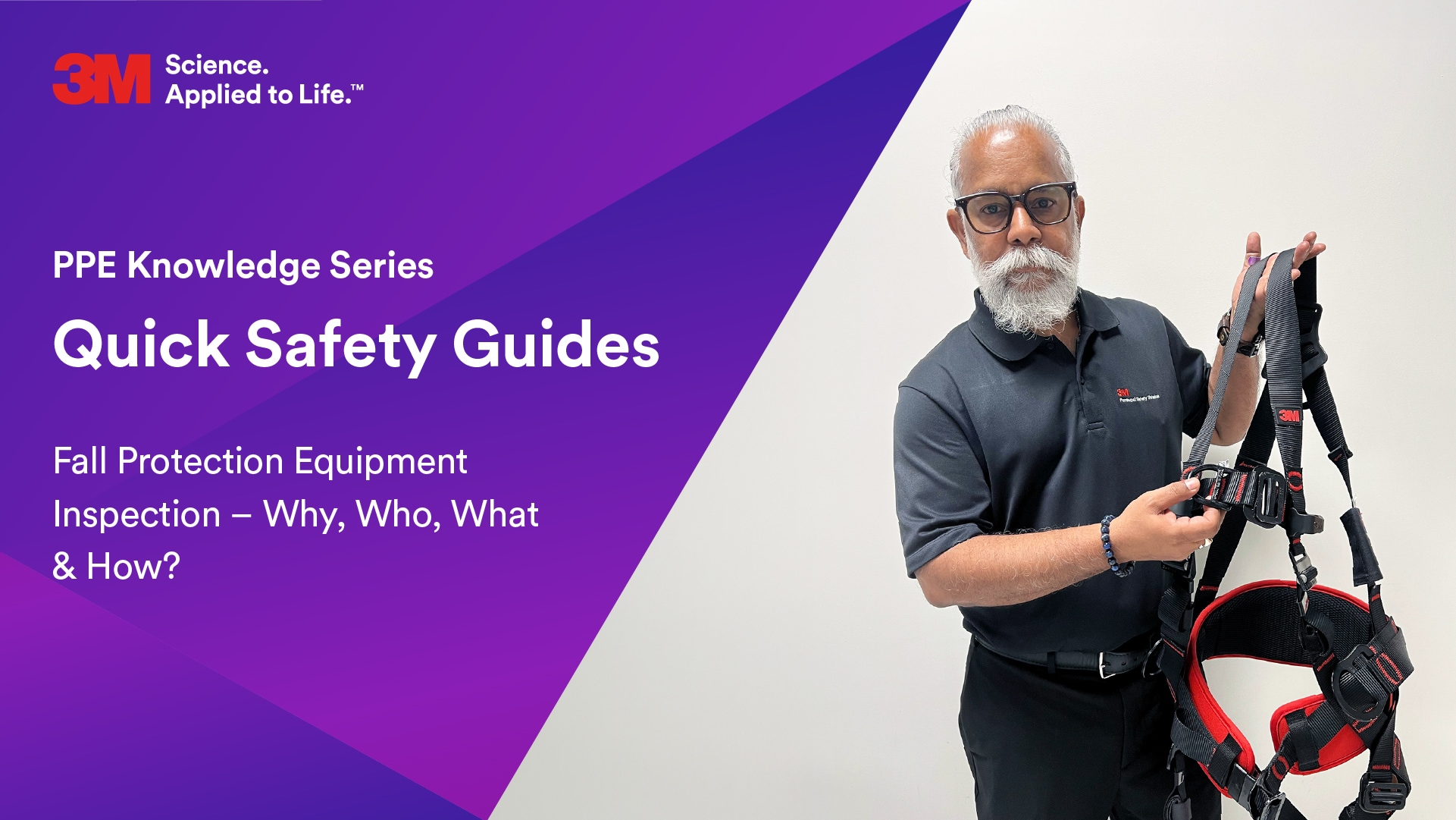 A person with a white beard and glasses holding a 3m harness