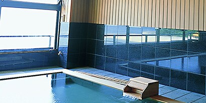 indoor swimming pool with anti-slip floor mats around pool deck
