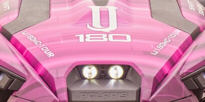A close up of a pink and white ATV with a white IJ180 logo on the hood, wrapped with 3M IJ180mC-10UR print wrap film.
