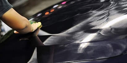A person cleaning a car
