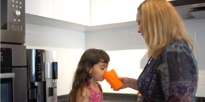 Family using 3M's water dispenser

