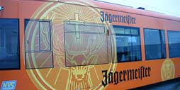 bright orange jagermeister branded graphic on the side of a rail car.