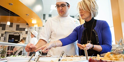 man and woman assembling food safely
