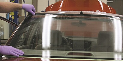 technician installing rear glass panel
