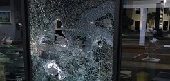 Shattered window shards being held together with protective window film
