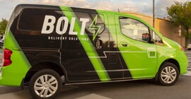 attention grabbing 3M fleet graphics on a commercial van driving through a city street