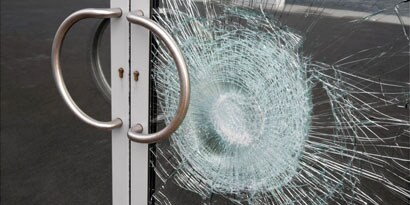 smashed window held together with window films
