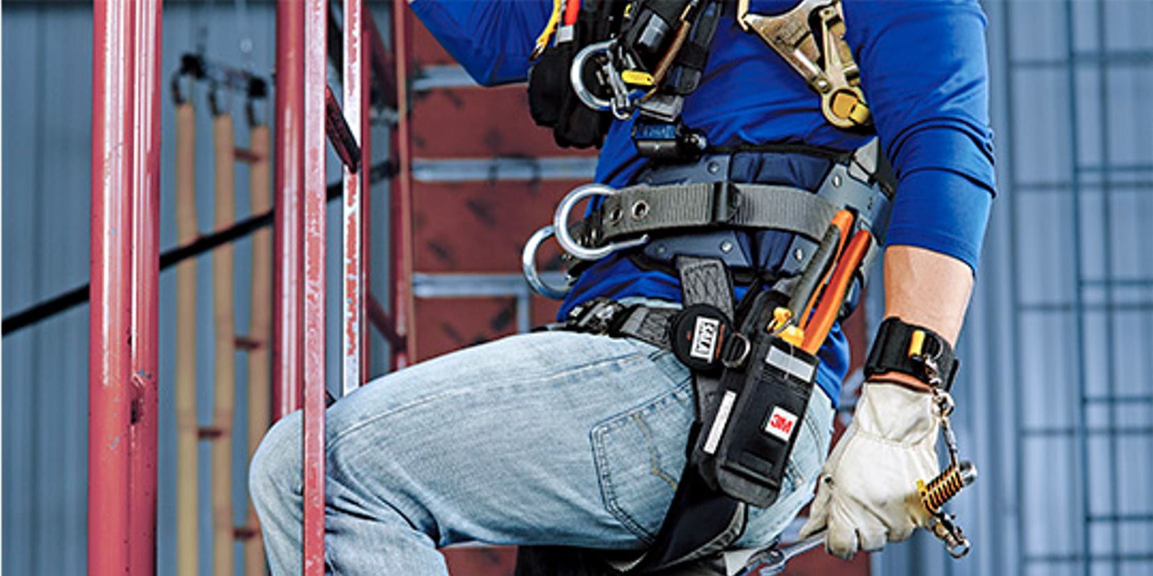 Worker at height with tools secured with pouch and tether