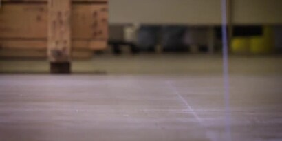 Video still of a rolling cart on a cleaned floor ready for the application of floor marking tape
