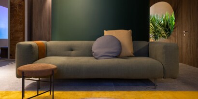 A couch with a round pillow
